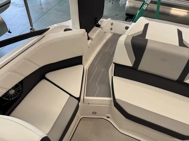 Slide: The Image of 2023 Regal 2000 ES boat interior with sleek white and gray seating design. - 9