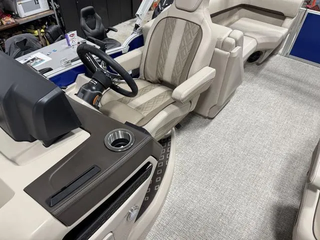 Slide: The Image of 2025 Bennington M Quad Bench 24 MFB interior with luxurious seating and modern dashboard. - 13