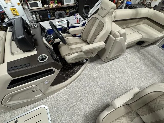 Slide: The Image of Interior of 2025 Bennington M Quad Bench 24 MFB pontoon boat, featuring luxurious seating and helm. - 14