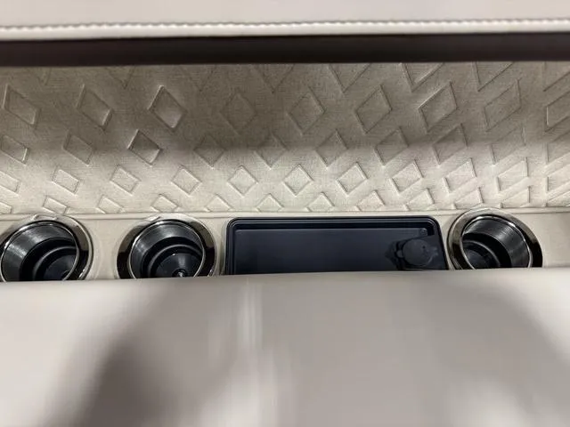 Slide: The Image of Interior of 2025 Bennington M Quad Bench 24 MFB with cup holders and textured panel. - 17
