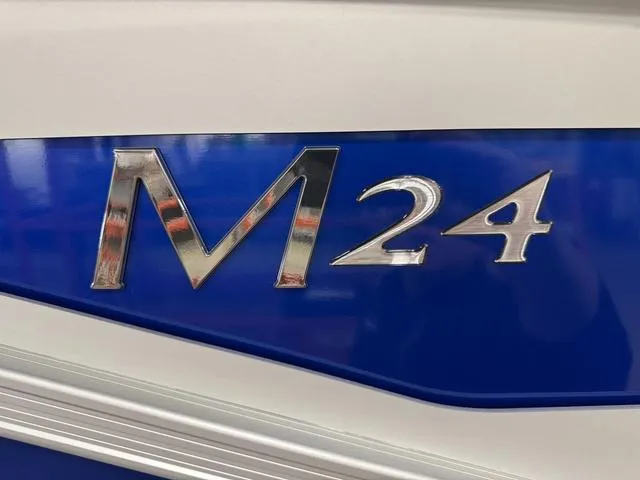 Slide: The Image of Bennington M Quad Bench 24 MFB 2025, blue and white exterior with M24 emblem. - 23