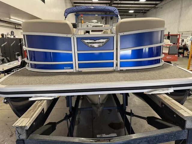 Slide: The Image of 2025 Bennington M Quad Bench 24 MFB pontoon boat in a workshop setting. - 3