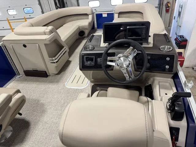 Slide: The Image of 2025 Bennington M Quad Bench 24 MFB interior with beige seating and modern dashboard. - 5