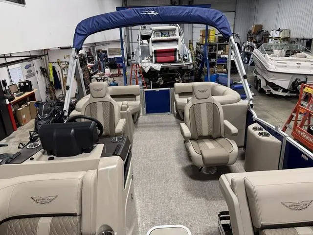 Slide: The Image of 2025 Bennington M Quad Bench 24 MFB pontoon boat in a workshop setting. - 7