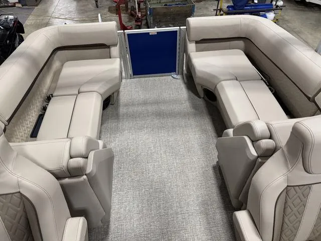 Slide: The Image of 2025 Bennington M Quad Bench 24 MFB interior with beige seating and carpeted floor. - 9