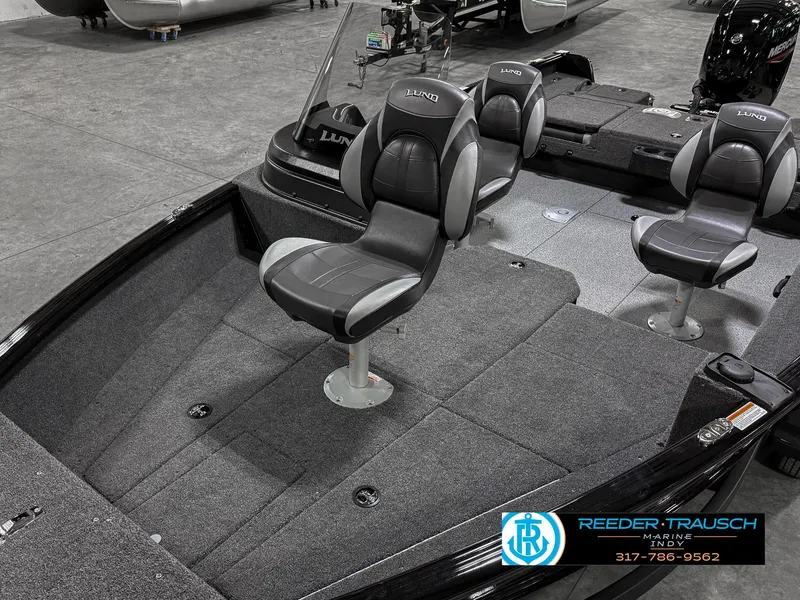 Slide: The Image of 2025 Lund 1775 IMPACT XS SINGLE boat interior with gray seating and carpeted deck. - 10