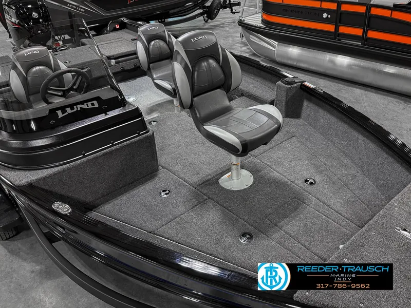 Slide: The Image of 2025 Lund 1775 Impact XS Single boat interior with seating and steering console. - 11