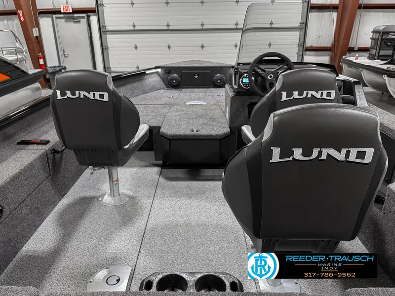 Slide: The Image of 2025 Lund 1775 Impact XS boat interior with four seats and steering console. - 14