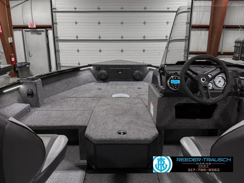 Slide: The Image of 2025 Lund 1775 Impact XS Single boat interior with steering console and seating. - 15