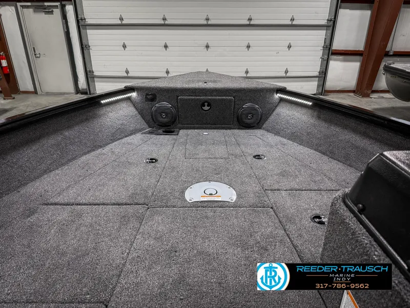 Slide: The Image of 2025 Lund 1775 Impact XS Single boat interior with carpeted deck and storage compartments. - 16