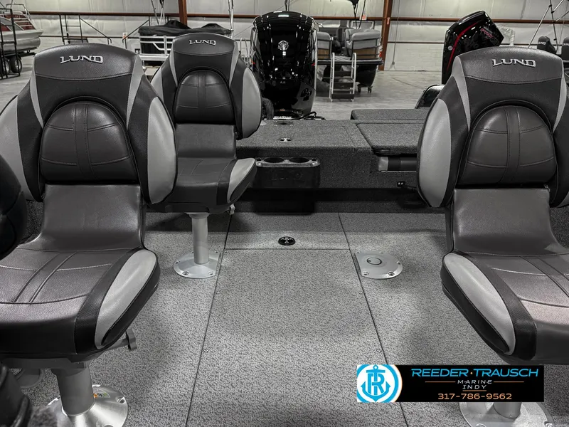 Slide: The Image of 2025 Lund 1775 IMPACT XS boat interior with gray seating and carpeted flooring. - 18