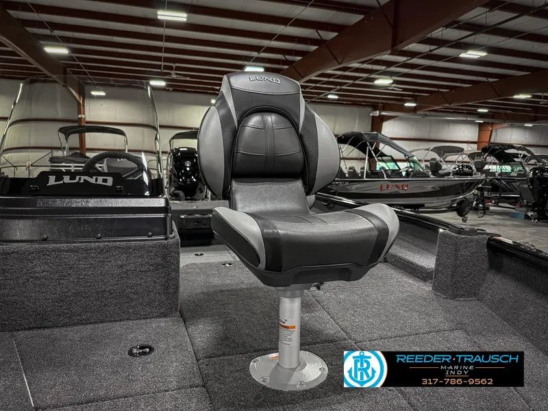 Slide: The Image of 2025 Lund 1775 Impact XS boat interior with a swivel seat in a showroom. - 25