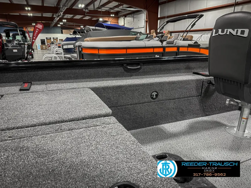 Slide: The Image of 2025 Lund 1775 Impact XS Single boat interior with seating and storage in showroom. - 26