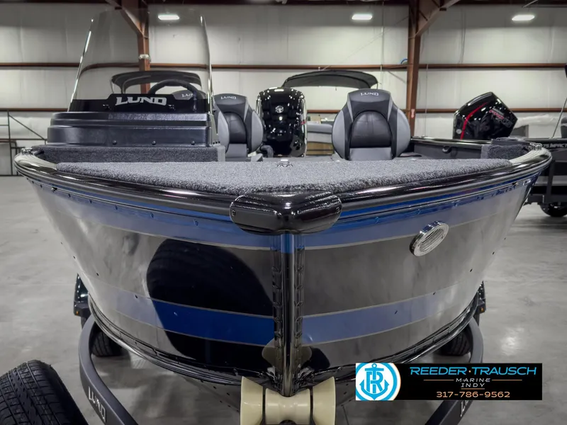 Slide: The Image of 2025 Lund 1775 Impact XS boat in showroom, front view, with trailer. - 3