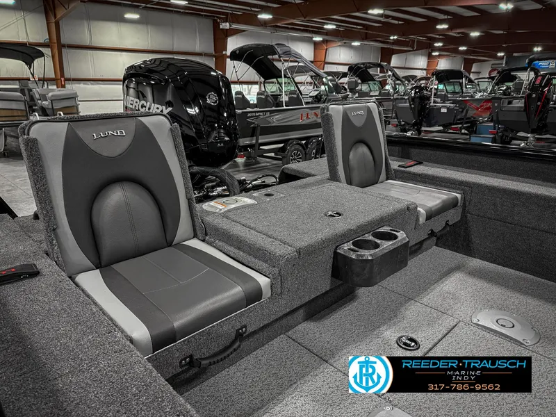 Slide: The Image of 2025 Lund 1775 IMPACT XS SINGLE boat interior with gray seating in showroom. - 31