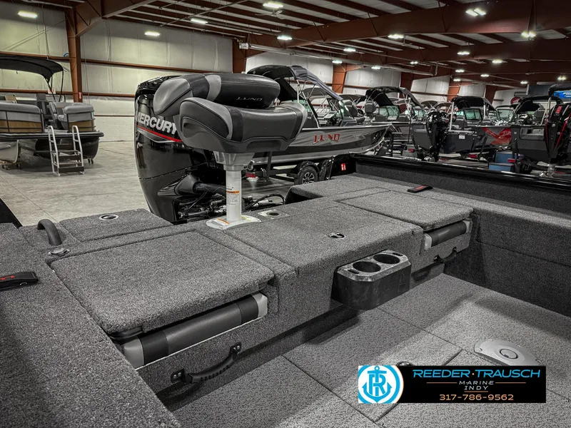 Slide: The Image of 2025 Lund 1775 Impact XS Single boat interior with Mercury engine in showroom. - 33