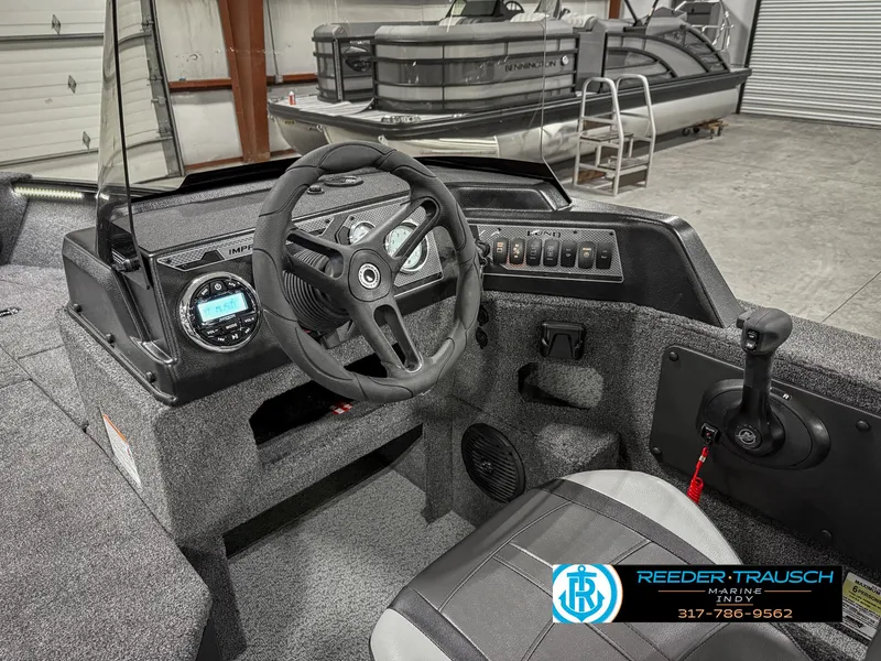 Slide: The Image of 2025 Lund 1775 Impact XS Single boat interior with steering wheel and control panel. - 35