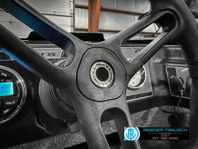 Slide: The Image of 2025 Lund 1775 IMPACT XS SINGLE boat dashboard with steering wheel and controls. - 36
