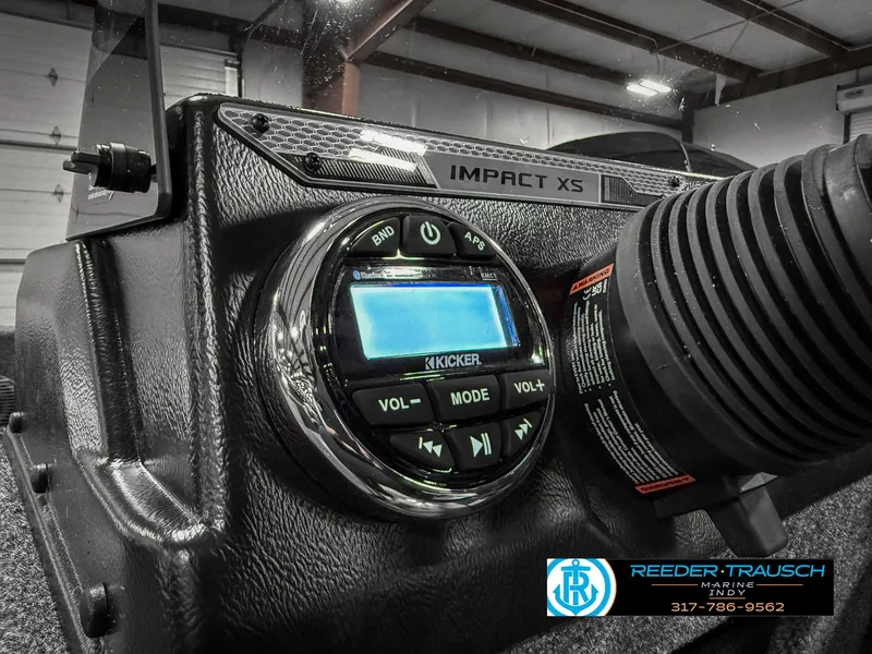 Slide: The Image of 2025 Lund 1775 IMPACT XS dashboard with Kicker audio system in a showroom. - 37