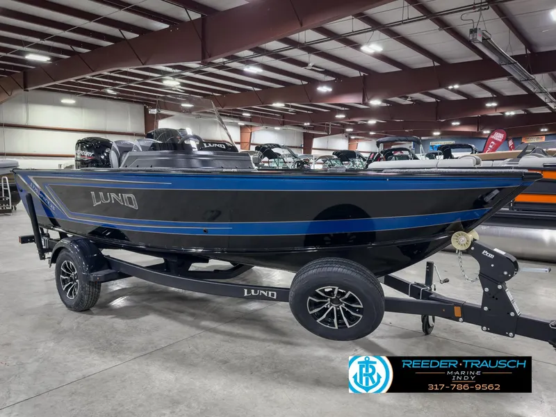 Slide: The Image of 2025 Lund 1775 IMPACT XS SINGLE boat displayed indoors on a trailer. - 4
