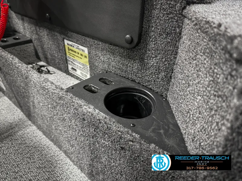 Slide: The Image of 2025 Lund 1775 Impact XS boat interior with cup holder and carpeted finish. - 45