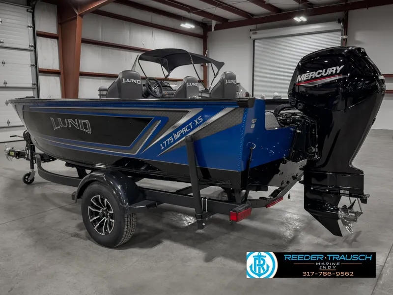 Slide: The Image of 2025 Lund 1775 IMPACT XS SINGLE boat with Mercury engine in a warehouse setting. - 8