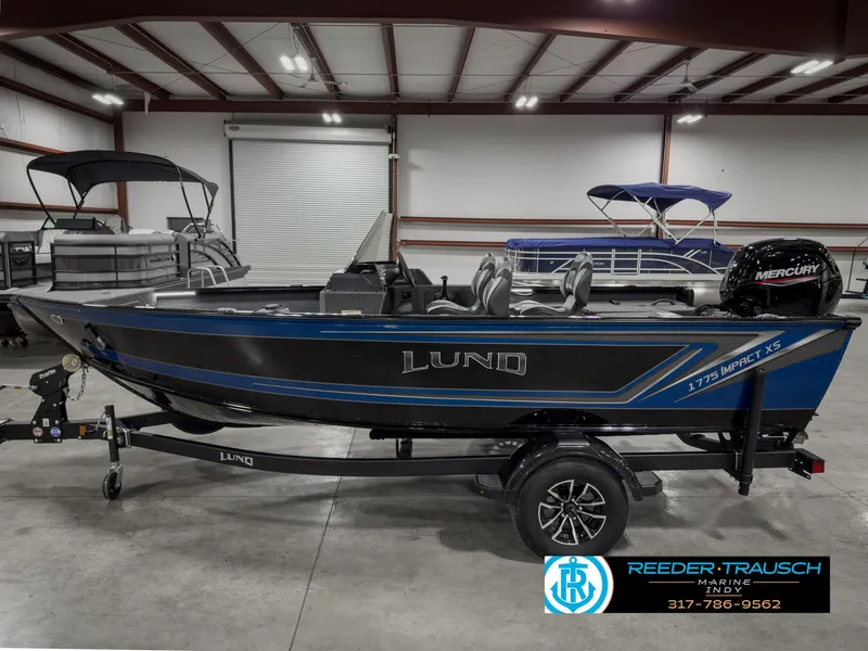 Slide: The Image of 2025 Lund 1775 Impact XS boat in showroom, side view, on trailer. - 9