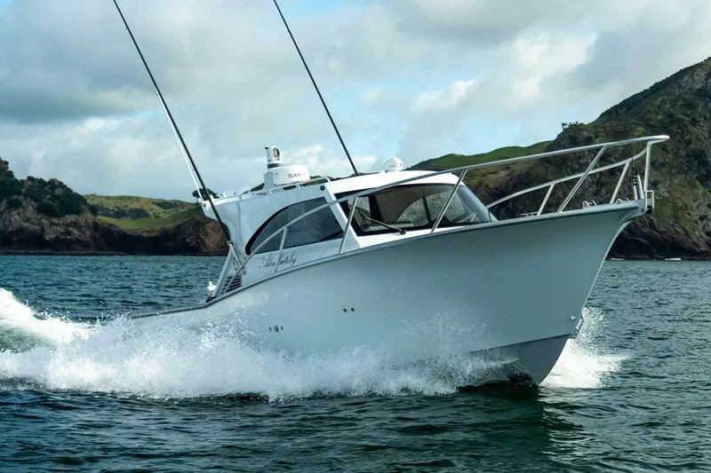 The Image of 2025 Makaira Gen3 1000 boat cruising on the ocean near rocky coastline. - 1