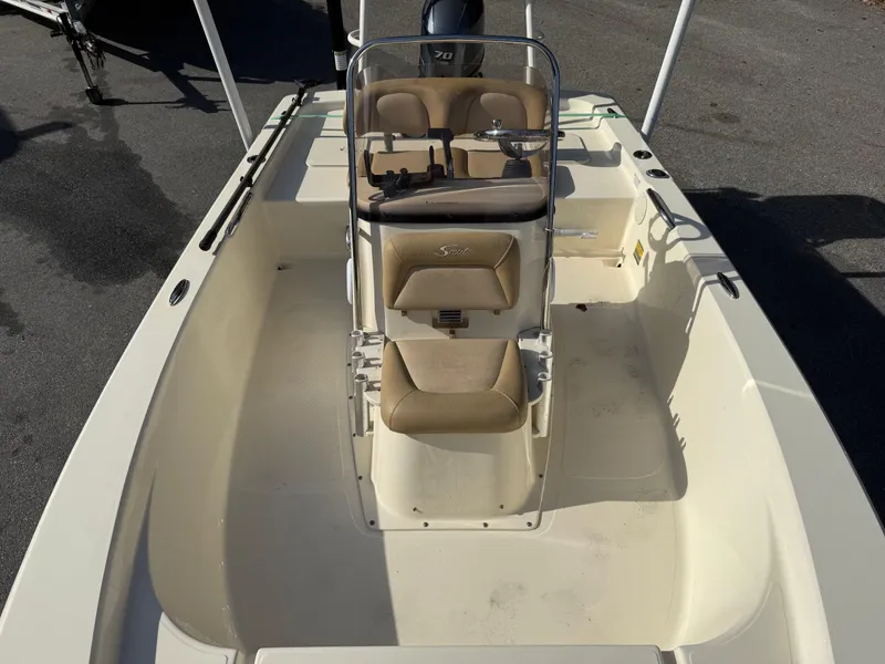 Slide: The Image of 2020 Scout 177 Sport boat interior with beige seating and steering console. - 3