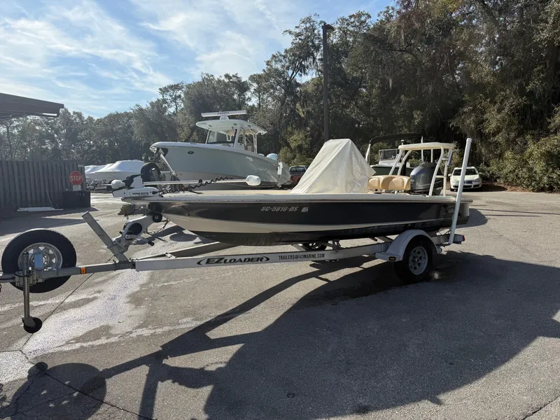 Slide: The Image of 2020 Scout 177 Sport boat on trailer in sunny outdoor setting. - 7