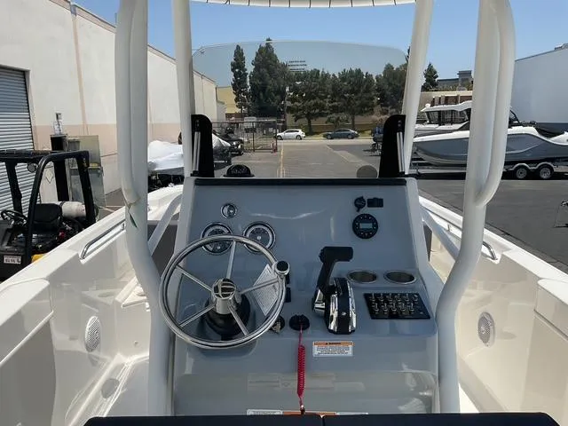 Slide: The Image of 2025 Bayliner Trophy T24CC boat console with steering wheel and controls. - 11