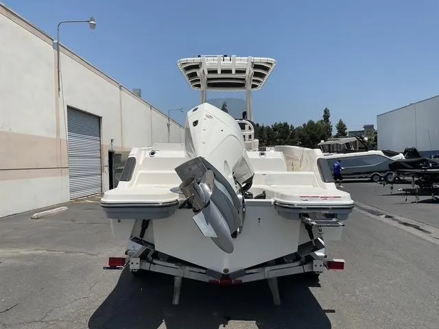 Slide: The Image of 2025 Bayliner Trophy T24CC boat on trailer, rear view, parked outdoors. - 2