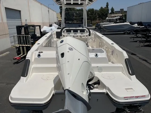 Slide: The Image of 2025 Bayliner Trophy T24CC boat with powerful outboard motor, displayed in a marina setting. - 8