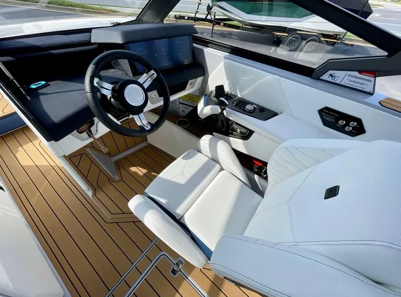 Slide: The Image of 2025 Nautique G23 boat interior with modern dashboard and luxurious seating. - 10