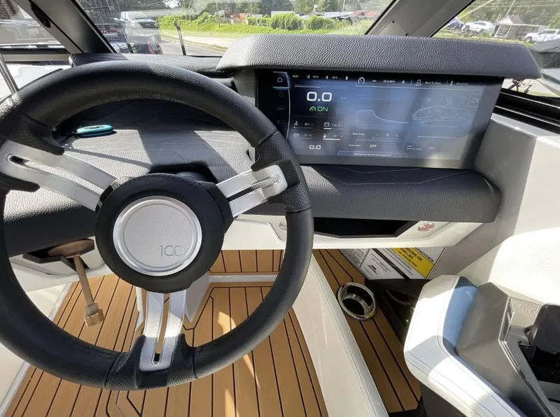 Slide: The Image of 2025 Nautique G23 dashboard with steering wheel and digital display. - 11
