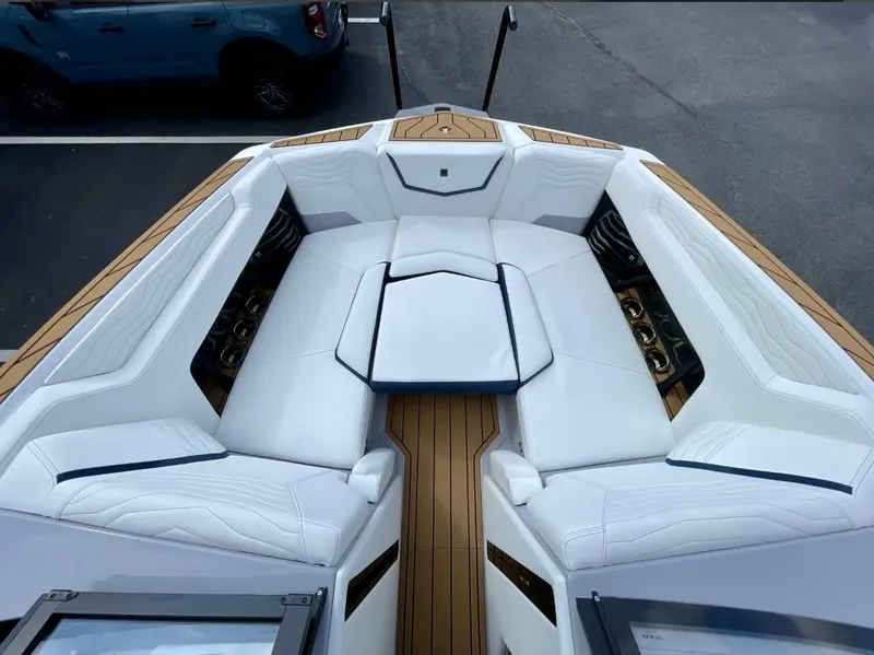 Slide: The Image of 2025 Nautique G23 boat interior with white seating and wood accents. - 17