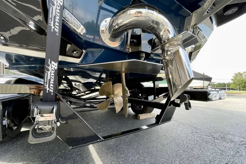 Slide: The Image of 2025 Nautique G23 boat propeller and exhaust system close-up. - 23