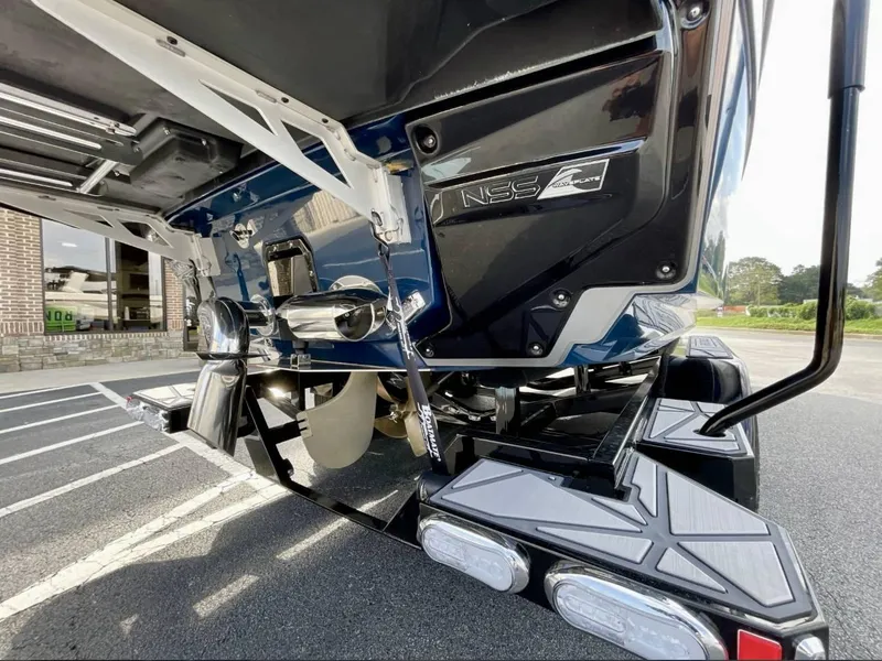 Slide: The Image of 2025 Nautique G23 boat rear view with NSS system and propeller detail. - 24