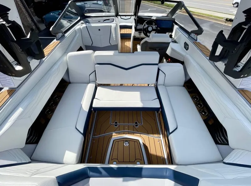 Slide: The Image of 2025 Nautique G23 boat interior with luxurious white seating and sleek design. - 7