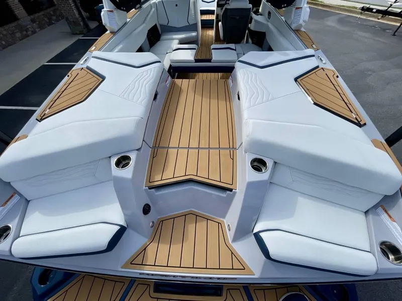 Slide: The Image of 2025 Nautique G23 boat interior with sleek seating and teak flooring. - 8