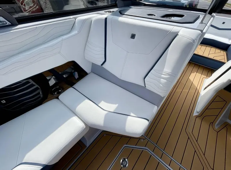 Slide: The Image of 2025 Nautique G23 interior with white seating and teak flooring. - 9