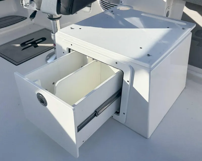 Slide: The Image of 2023 Sea Pro 240 DC boat storage compartment with open drawer, showcasing interior space. - 13