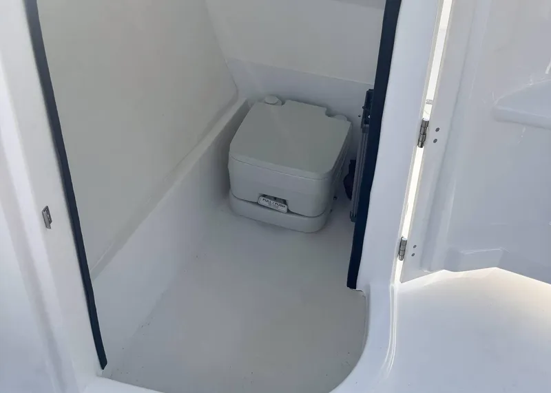 Slide: The Image of 2023 Sea Pro 240 DC boat interior with compact portable toilet. - 17