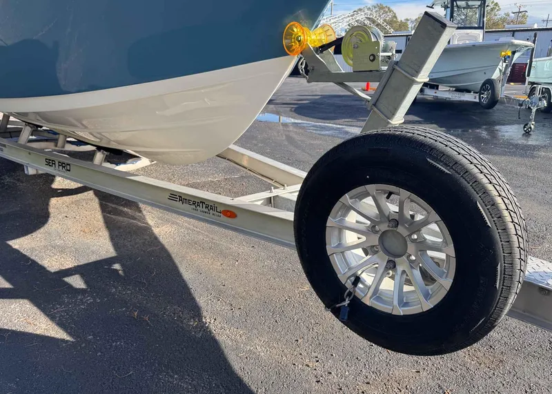 Slide: The Image of 2023 Sea Pro 240 DC boat on AmeraTrail trailer, close-up of wheel and hull. - 19