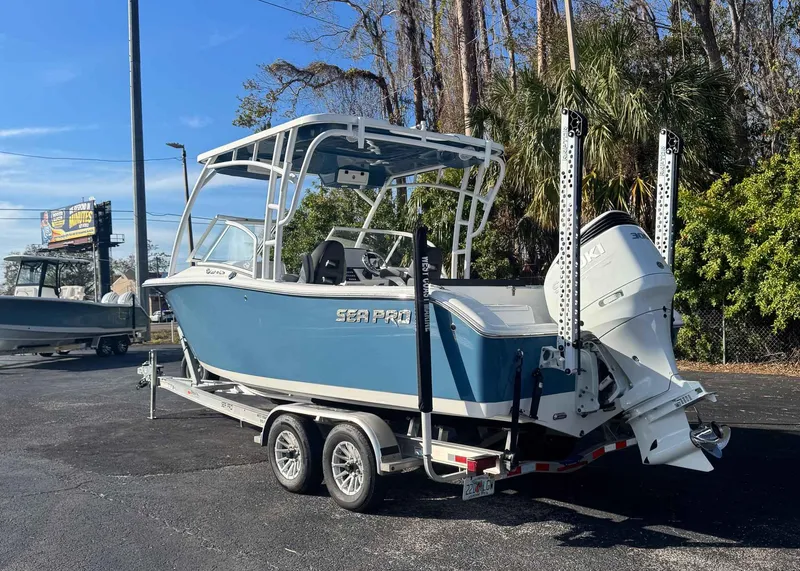 Slide: The Image of 2023 Sea Pro 240 DC boat on trailer, parked outdoors. - 3