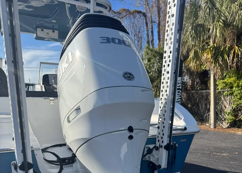 Slide: The Image of 2023 Sea Pro 240 DC boat with Suzuki 300 outboard motor, parked outdoors. - 5