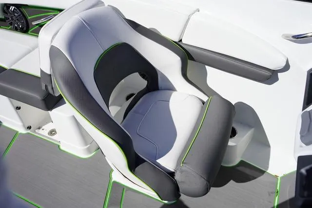 Slide: The Image of 2024 Tahoe 210 S boat seat with gray and white upholstery, accented by green trim. - 10