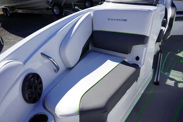 Slide: The Image of 2024 Tahoe 210 S boat interior with gray and white seating, green accents, and speaker. - 12