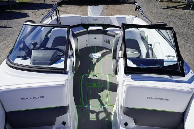 Slide: The Image of 2024 Tahoe 210 S boat interior with open windshield, gray and green seating, and modern design. - 13