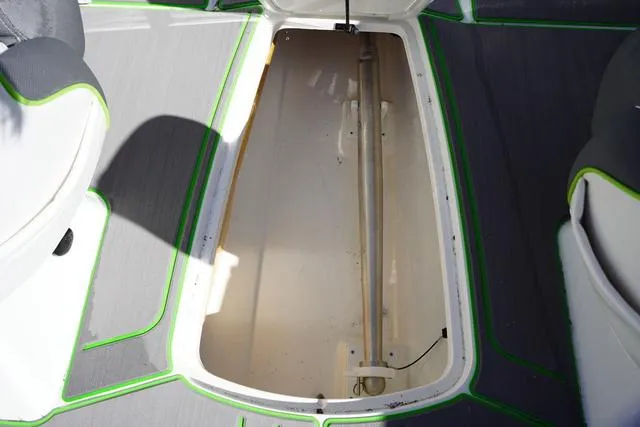 Slide: The Image of 2024 Tahoe 210 S boat storage compartment with gray and green trim. - 16